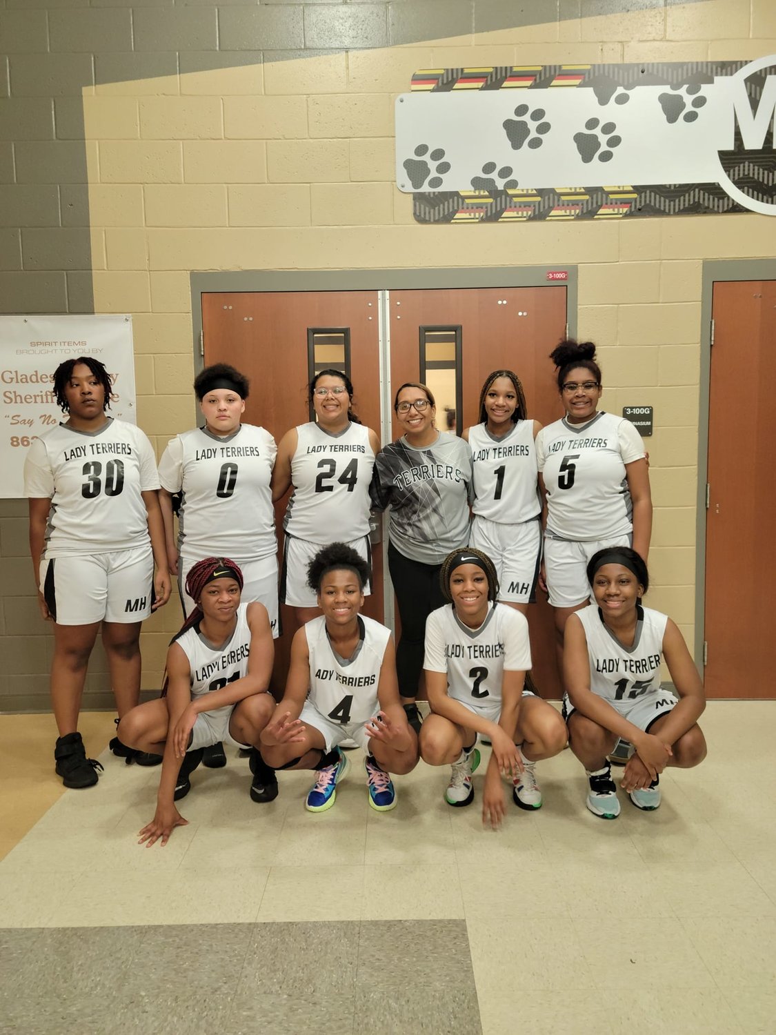 Moore Haven Middle-High School girls' varsity basketball team celebrates win.